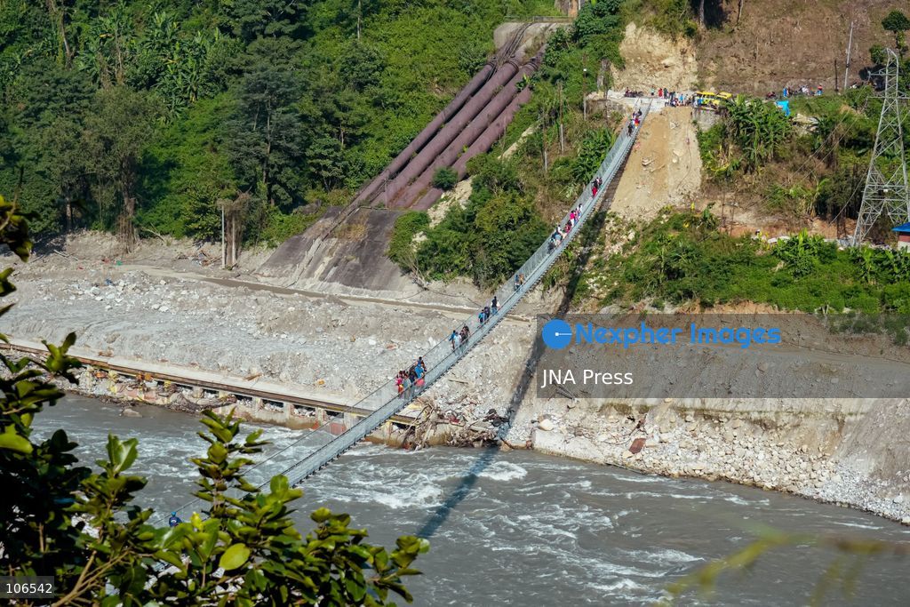 NUWAKOT, NEPAL, OCTOBER 15, 2026: People cross a newly built suspension bridge over the Trishuli River in Bidur Municipality, Nuwakot District. The footbridge restores access between communities after flooding along the Bhotekoshi–Trishuli river corridor swept away road bridges and disrupted local transport. Photo by Ambir Tolang / JNA Press. (Photo by Ambir Tolang/JNA Press via Nexpher Images)