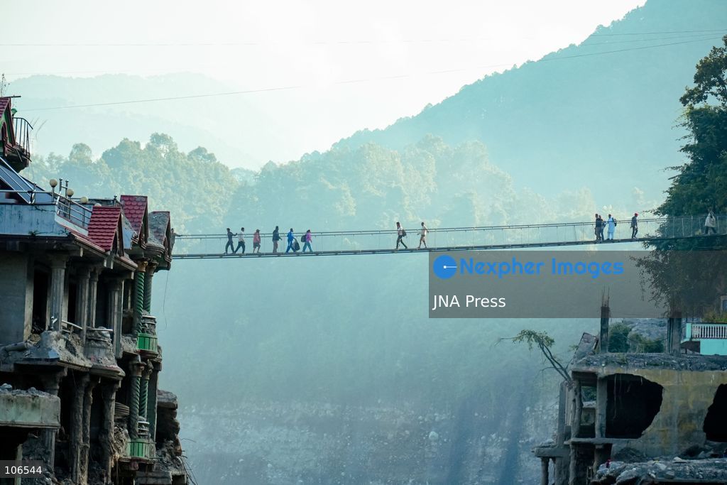 NUWAKOT, NEPAL, OCTOBER 15, 2026: People cross a newly built suspension bridge over the Trishuli River in Bidur Municipality, Nuwakot District. The footbridge restores access between communities after flooding along the Bhotekoshi–Trishuli river corridor swept away road bridges and disrupted local transport. Photo by Ambir Tolang / JNA Press. (Photo by Ambir Tolang/JNA Press via Nexpher Images)