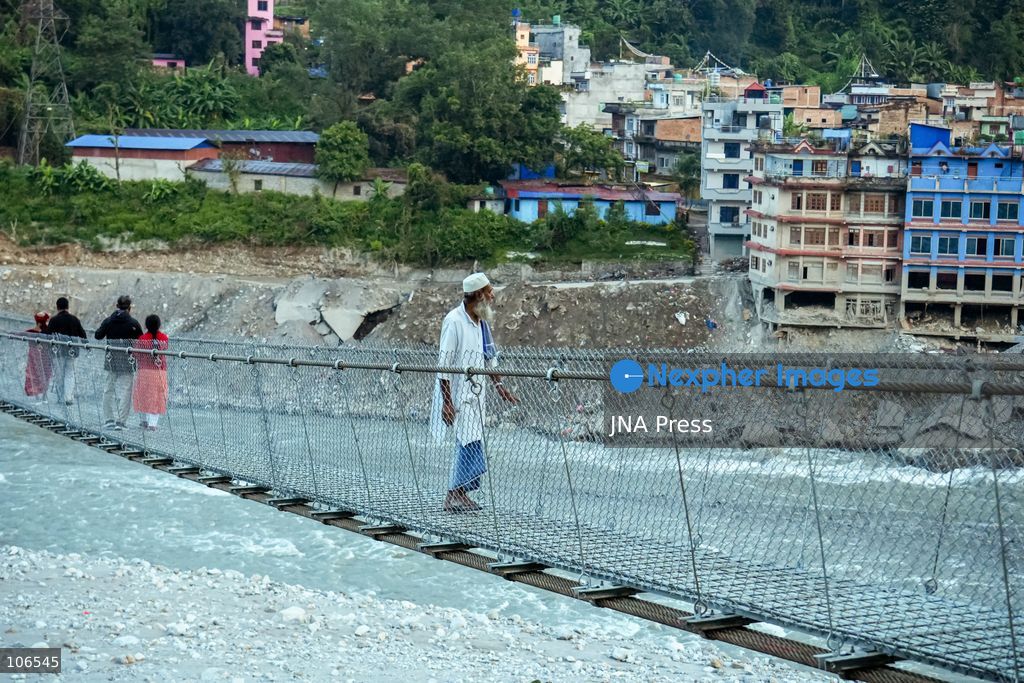 NUWAKOT, NEPAL, OCTOBER 15, 2026: People cross a newly built suspension bridge over the Trishuli River in Bidur Municipality, Nuwakot District. The footbridge restores access between communities after flooding along the Bhotekoshi–Trishuli river corridor swept away road bridges and disrupted local transport. Photo by Ambir Tolang / JNA Press. (Photo by Ambir Tolang/JNA Press via Nexpher Images)