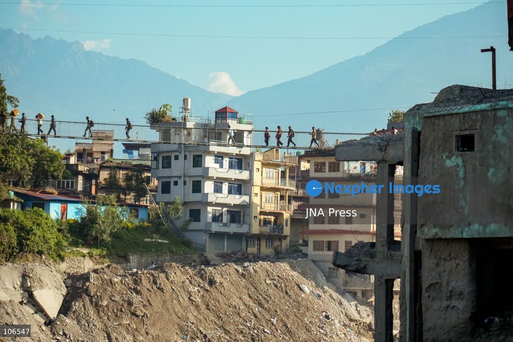 NUWAKOT, NEPAL, OCTOBER 15, 2026: People cross a newly built suspension bridge over the Trishuli River in Bidur Municipality, Nuwakot District. The footbridge restores access between communities after flooding along the Bhotekoshi–Trishuli river corridor swept away road bridges and disrupted local transport. Photo by Ambir Tolang / JNA Press. (Photo by Ambir Tolang/JNA Press via Nexpher Images)