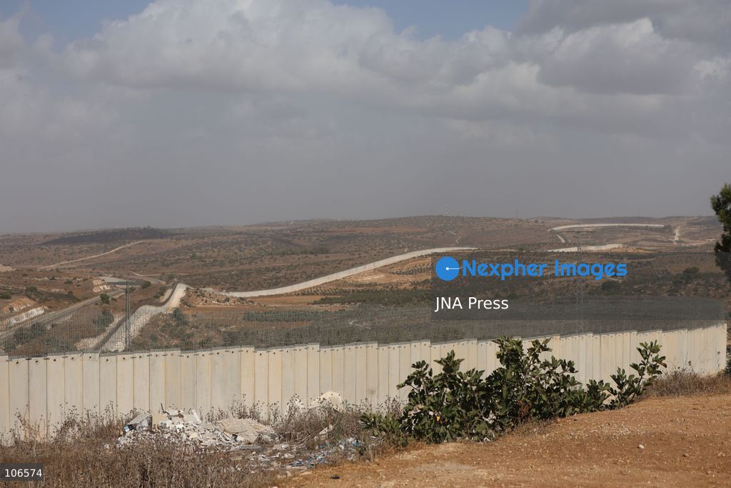 BEIT AWWA, PALESTINE, OCTOBER 15, 2026: Palestinian farmers harvest olives near the Israeli-built separation wall in Beit Awwa, southwest of Hebron in the occupied West Bank, during the annual olive harvest season. Photo by Mosab Shawer / JNA Press. (Photo by Mosab shawer/JNA Press via Nexpher Images)