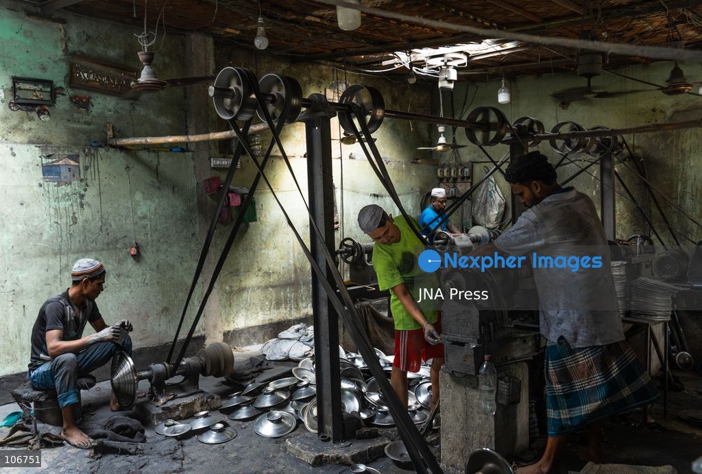 DHAKA, BANGLADESH, OCTOBER 16, 2026: Children work alongside adults at an aluminium cookware factory in Kamrangirchar, Dhaka. Workers handle materials, shape metal and organise finished pots, pans and other household utensils at the small-scale workshop. Photo by Shamim Ul Islam / JNA Press. (Photo by Md shamim Ul islam/JNA Press via Nexpher Images)