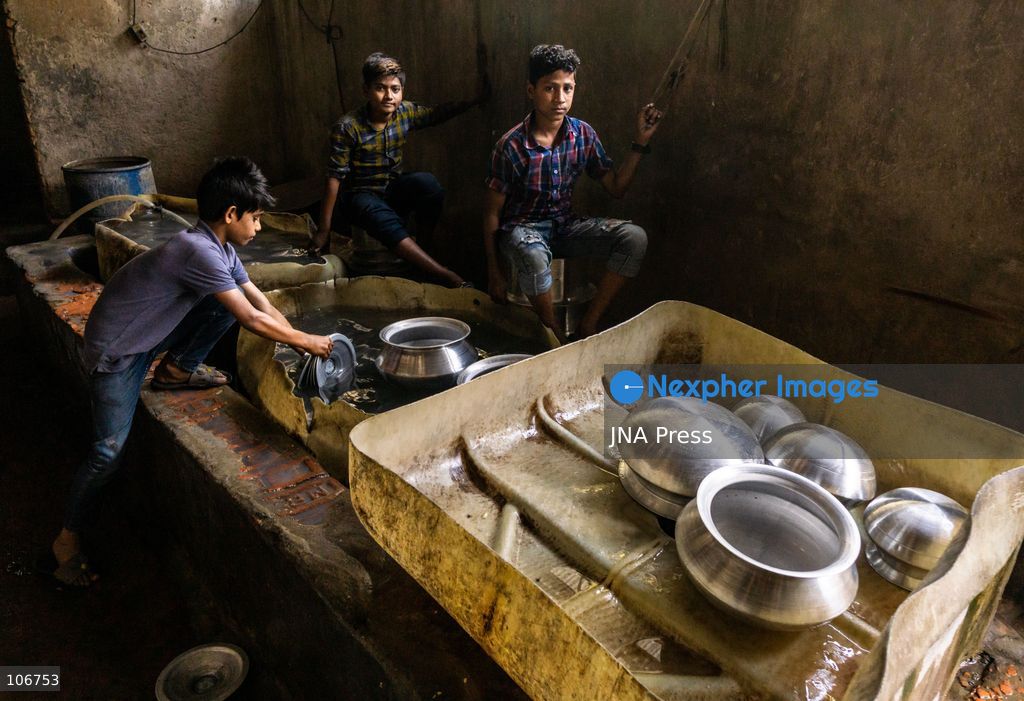 DHAKA, BANGLADESH, OCTOBER 16, 2026: Children work alongside adults at an aluminium cookware factory in Kamrangirchar, Dhaka. Workers handle materials, shape metal and organise finished pots, pans and other household utensils at the small-scale workshop. Photo by Shamim Ul Islam / JNA Press. (Photo by Md shamim Ul islam/JNA Press via Nexpher Images)