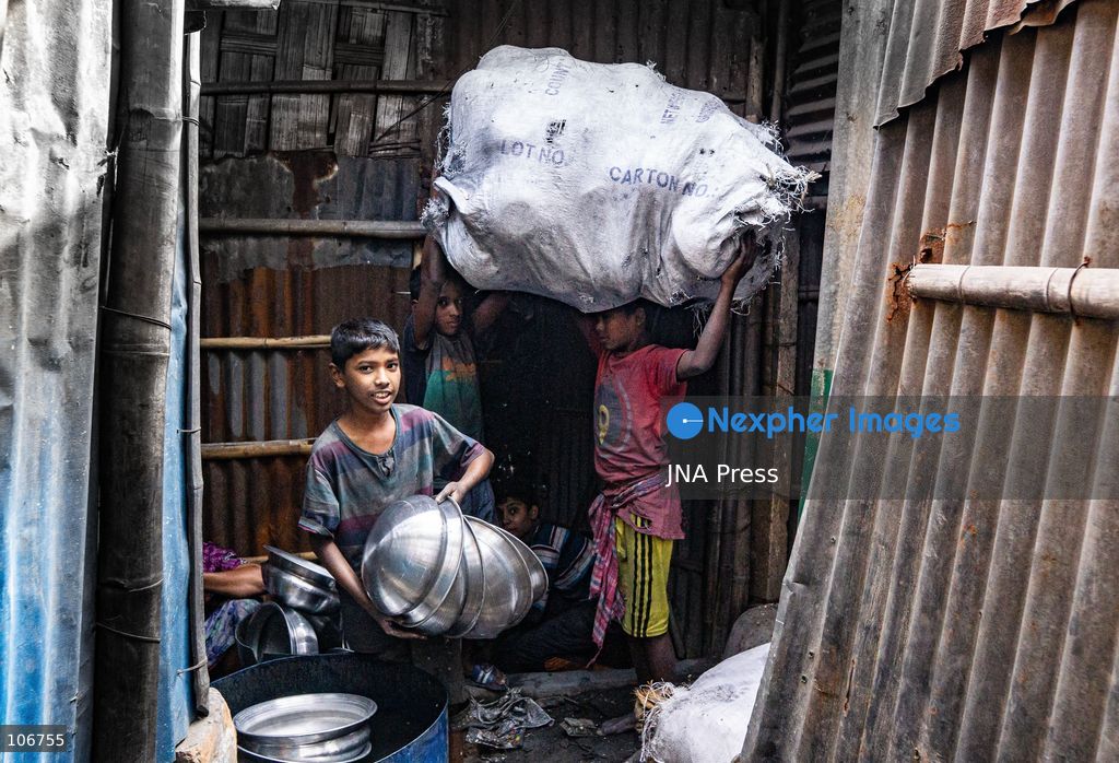 DHAKA, BANGLADESH, OCTOBER 16, 2026: Children work alongside adults at an aluminium cookware factory in Kamrangirchar, Dhaka. Workers handle materials, shape metal and organise finished pots, pans and other household utensils at the small-scale workshop. Photo by Shamim Ul Islam / JNA Press. (Photo by Md shamim Ul islam/JNA Press via Nexpher Images)