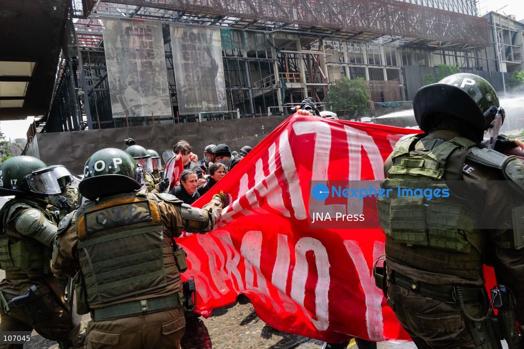 SANTIAGO, CHILE - OCTOBER 18, 2026: Carabineros officers pull at a red banner held by demonstrators while trying to clear the street outside the GAM during the seventh anniversary of Chile's 2019 social uprising. (Photo by Pablo Zamorano/JNA Press via Nexpher Images)