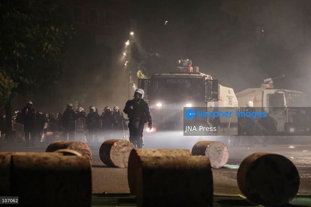 TIRANA, ALBANIA, OCTOBER 18, 2026: Demonstrators clash with riot police in Skanderbeg Square as student-led anti-government protests continue for a sixth consecutive day. Confrontations spread from the Ministry of Education to central Tirana, with protesters throwing stones and pyrotechnics while police deploy tear gas and water cannons. Demonstrators demand improved university conditions and the resignation of Prime Minister Edi Rama. (Photo by Vlasov Sulaj/JNA Press via Nexpher Images)