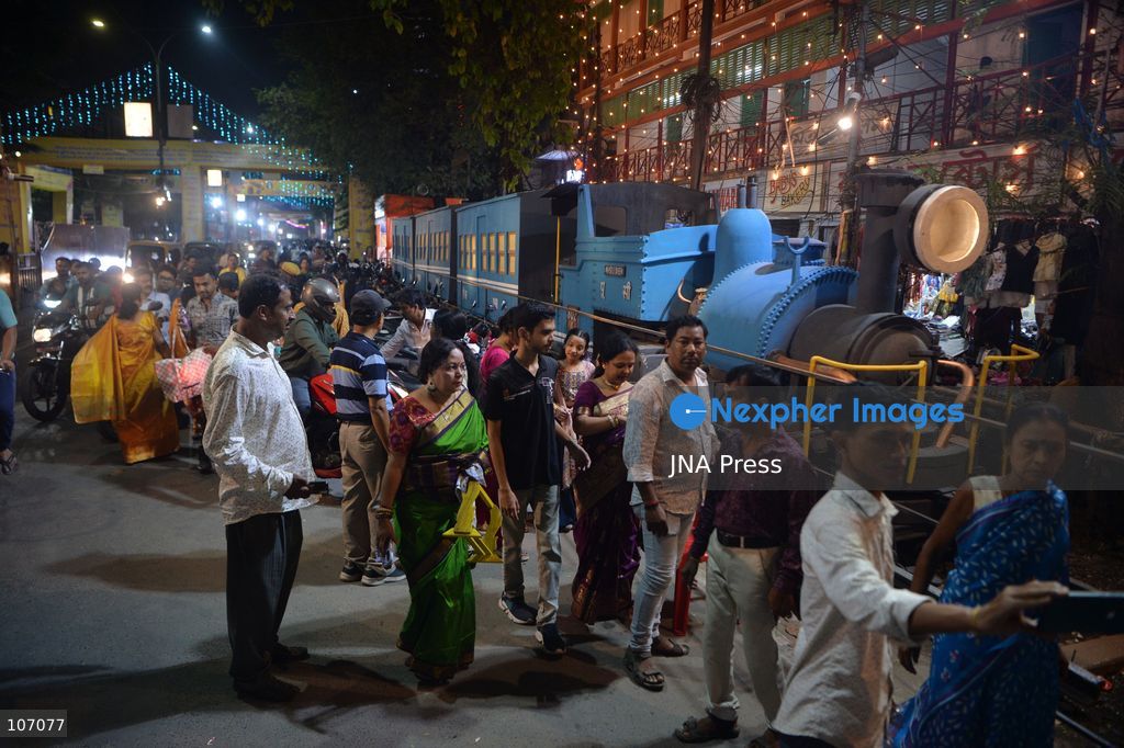 SILIGURI, INDIA - OCTOBER 19, 2026: Visitors gather at the Mitra Sammilani Puja Pandal in Siliguri. Mitra Sammilani, one of the oldest cultural organizations in Siliguri, is celebrating the centenary year of its Durga Puja. A major attraction is a replica of the Darjeeling Himalayan Railway (DHR), also known as the Toy Train, along with a recreation of the town's streets from a century ago, with figures of ordinary people traveling in bullock carts and horse-drawn carriages to attend the puja. (Photo by DIPTENDU DUTTA/JNA Press via Nexpher Images)