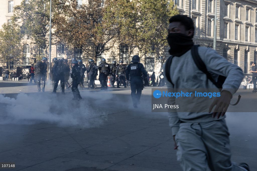 PARIS, FRANCE - OCTOBER 18, 2026: Protesters clash with police near Place de la République in Paris during a protest against austerity. Protesters set up makeshift barricades and start fires in the square and surrounding streets. After police clear the square, protesters attack nearby shops. (Photo by Oualid Abdellaoui/JNA Press via Nexpher Images)