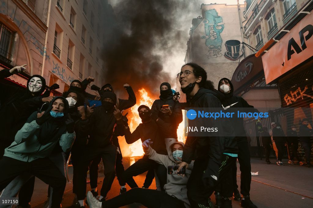 PARIS, FRANCE - OCTOBER 18, 2026: Protesters clash with police near Place de la République in Paris during a protest against austerity. Protesters set up makeshift barricades and start fires in the square and surrounding streets. After police clear the square, protesters attack nearby shops. (Photo by Oualid Abdellaoui/JNA Press via Nexpher Images)