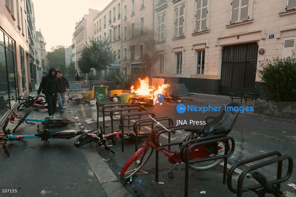 PARIS, FRANCE - OCTOBER 18, 2026: Protesters clash with police near Place de la République in Paris during a protest against austerity. Protesters set up makeshift barricades and start fires in the square and surrounding streets. After police clear the square, protesters attack nearby shops. (Photo by Oualid Abdellaoui/JNA Press via Nexpher Images)