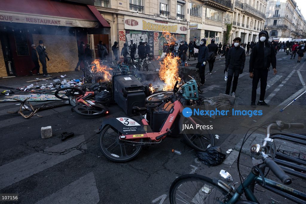 PARIS, FRANCE - OCTOBER 18, 2026: Protesters clash with police near Place de la République in Paris during a protest against austerity. Protesters set up makeshift barricades and start fires in the square and surrounding streets. After police clear the square, protesters attack nearby shops. (Photo by Oualid Abdellaoui/JNA Press via Nexpher Images)
