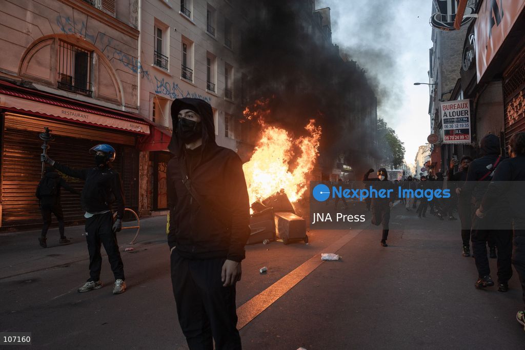 PARIS, FRANCE - OCTOBER 18, 2026: Protesters clash with police near Place de la République in Paris during a protest against austerity. Protesters set up makeshift barricades and start fires in the square and surrounding streets. After police clear the square, protesters attack nearby shops. (Photo by Oualid Abdellaoui/JNA Press via Nexpher Images)