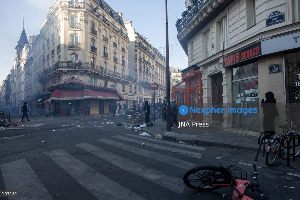 PARIS, FRANCE - OCTOBER 18, 2026: Protesters clash with police near Place de la République in Paris during a protest against austerity. Protesters set up makeshift barricades and start fires in the square and surrounding streets. After police clear the square, protesters attack nearby shops. (Photo by Oualid Abdellaoui/JNA Press via Nexpher Images)