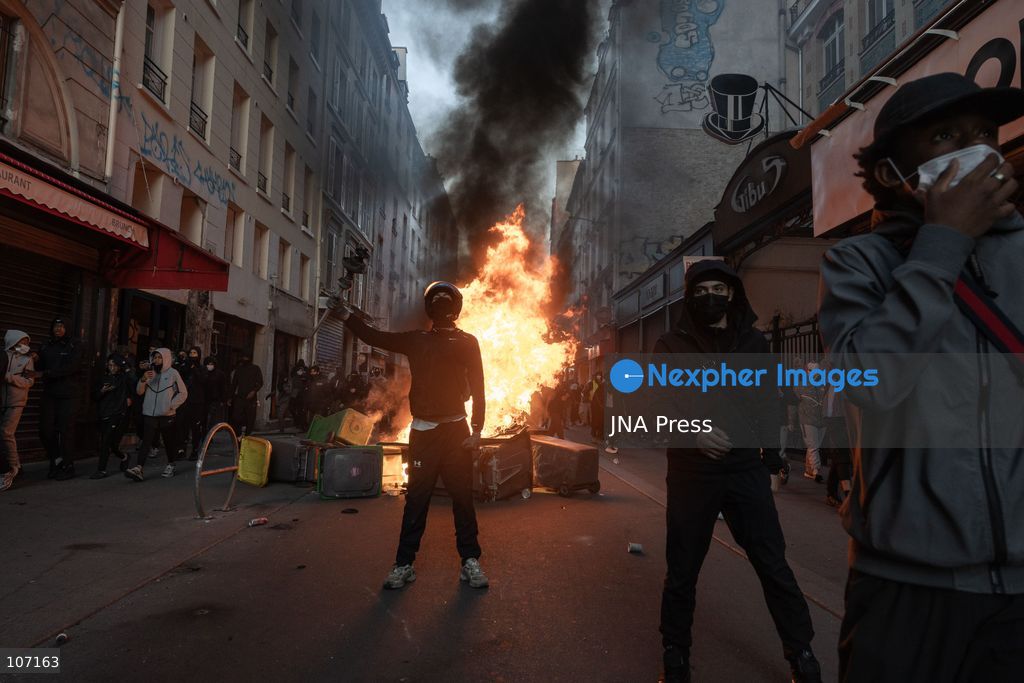 PARIS, FRANCE - OCTOBER 18, 2026: Protesters clash with police near Place de la République in Paris during a protest against austerity. Protesters set up makeshift barricades and start fires in the square and surrounding streets. After police clear the square, protesters attack nearby shops. (Photo by Oualid Abdellaoui/JNA Press via Nexpher Images)