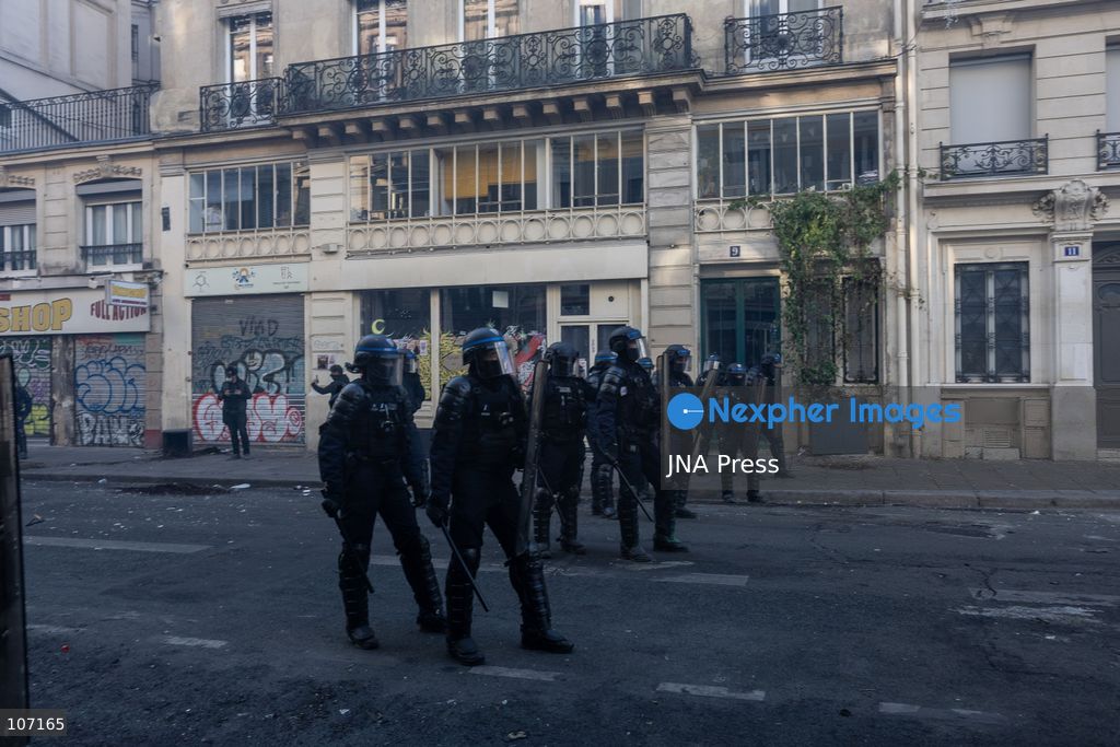 PARIS, FRANCE - OCTOBER 18, 2026: Protesters clash with police near Place de la République in Paris during a protest against austerity. Protesters set up makeshift barricades and start fires in the square and surrounding streets. After police clear the square, protesters attack nearby shops. (Photo by Oualid Abdellaoui/JNA Press via Nexpher Images)