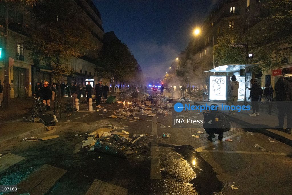 PARIS, FRANCE - OCTOBER 18, 2026: Protesters clash with police near Place de la République in Paris during a protest against austerity. Protesters set up makeshift barricades and start fires in the square and surrounding streets. After police clear the square, protesters attack nearby shops. (Photo by Oualid Abdellaoui/JNA Press via Nexpher Images)