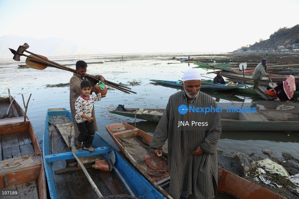 BANDIPORA, INDIA - OCTOBER 19, 2026: Fishermen cast their nets while women and other workers collect water chestnuts at Wular Lake in Bandipora district of Kashmir. Many families in the area earn their livelihoods from the lake's waters. (Photo by Kamran Yousuf/JNA Press via Nexpher Images)