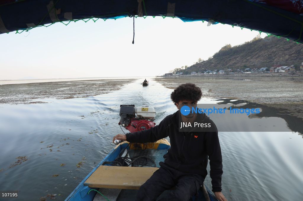 BANDIPORA, INDIA - OCTOBER 19, 2026: Fishermen cast their nets while women and other workers collect water chestnuts at Wular Lake in Bandipora district of Kashmir. Many families in the area earn their livelihoods from the lake's waters. (Photo by Kamran Yousuf/JNA Press via Nexpher Images)