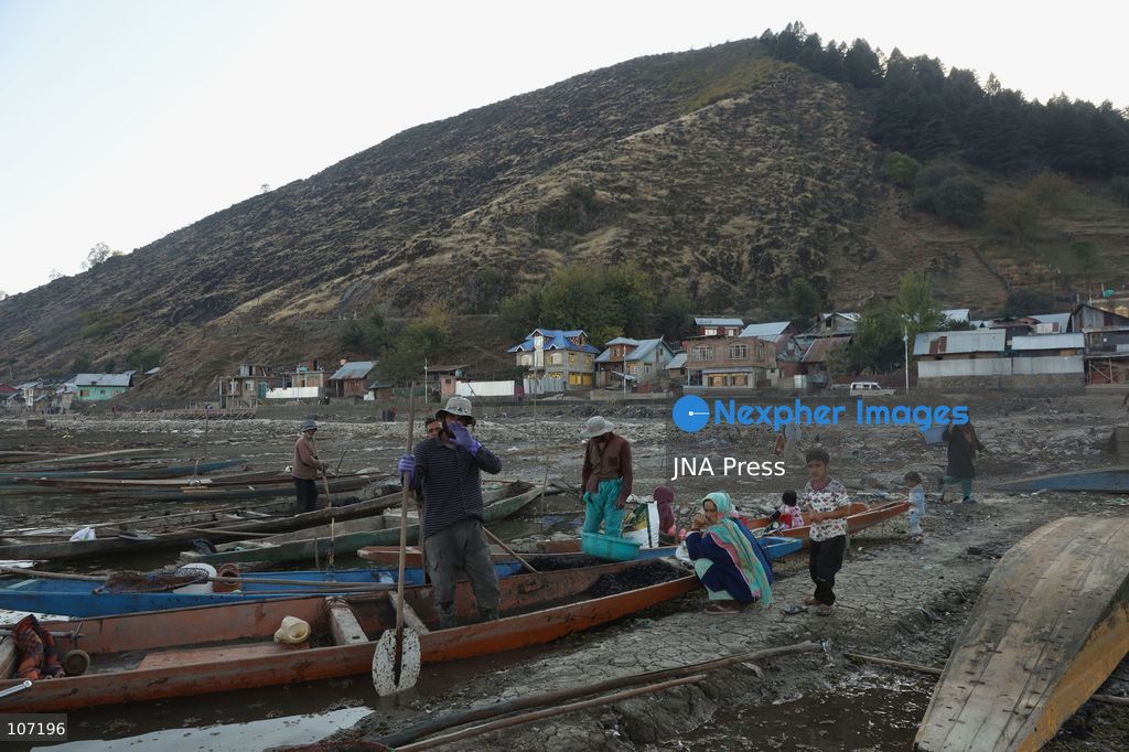BANDIPORA, INDIA - OCTOBER 19, 2026: Fishermen cast their nets while women and other workers collect water chestnuts at Wular Lake in Bandipora district of Kashmir. Many families in the area earn their livelihoods from the lake's waters. (Photo by Kamran Yousuf/JNA Press via Nexpher Images)
