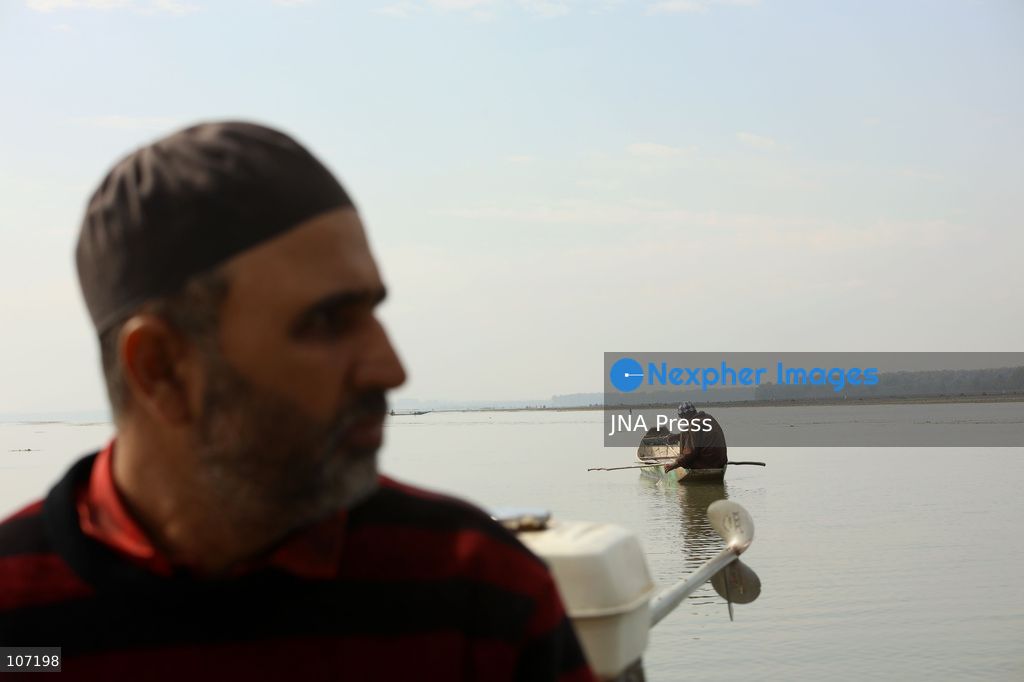BANDIPORA, INDIA - OCTOBER 19, 2026: Fishermen cast their nets while women and other workers collect water chestnuts at Wular Lake in Bandipora district of Kashmir. Many families in the area earn their livelihoods from the lake's waters. (Photo by Kamran Yousuf/JNA Press via Nexpher Images)