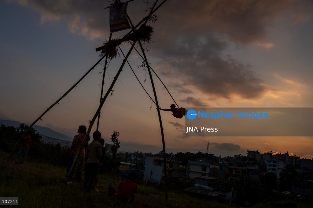 BHAKTAPUR, NEPAL - OCTOBER 19, 2026: Locals enjoy a traditional swing set up in Duwakot, Bhaktapur, Nepal, during the Dashain festival. According to tradition, people should leave the ground at least once during Dashain by riding a swing. Swings are set up in various parts of the country and draw crowds, especially after people receive tika blessings. (Photo by Ghanashyam Shrestha/JNA Press via Nexpher Images)