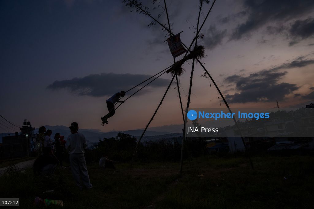 BHAKTAPUR, NEPAL - OCTOBER 19, 2026: Locals enjoy a traditional swing set up in Duwakot, Bhaktapur, Nepal, during the Dashain festival. According to tradition, people should leave the ground at least once during Dashain by riding a swing. Swings are set up in various parts of the country and draw crowds, especially after people receive tika blessings. (Photo by Ghanashyam Shrestha/JNA Press via Nexpher Images)