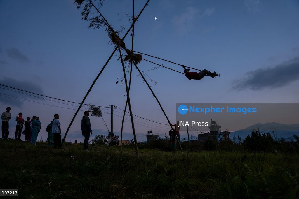 BHAKTAPUR, NEPAL - OCTOBER 19, 2026: Locals enjoy a traditional swing set up in Duwakot, Bhaktapur, Nepal, during the Dashain festival. According to tradition, people should leave the ground at least once during Dashain by riding a swing. Swings are set up in various parts of the country and draw crowds, especially after people receive tika blessings. (Photo by Ghanashyam Shrestha/JNA Press via Nexpher Images)
