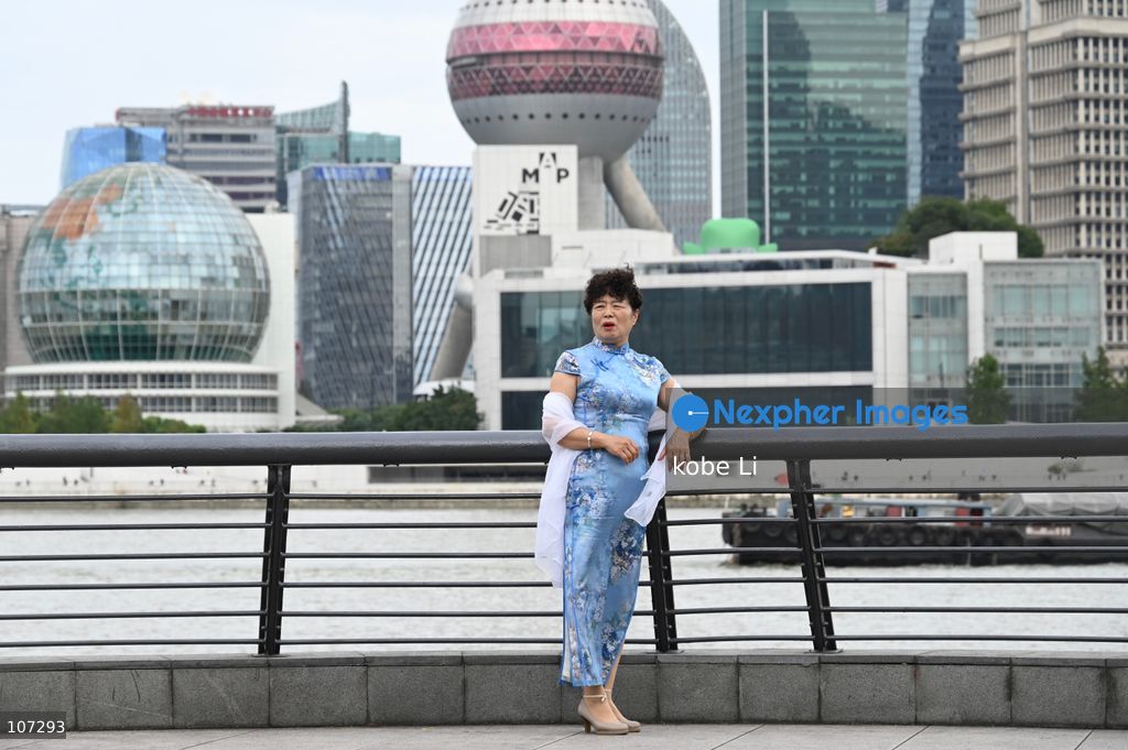 A general view showing a woman posing photo with the Oriental Pearl Tower at the Bund on October 16, 2026 in Shanghai, China. (Photo by kobe Li/Nexpher Images)
