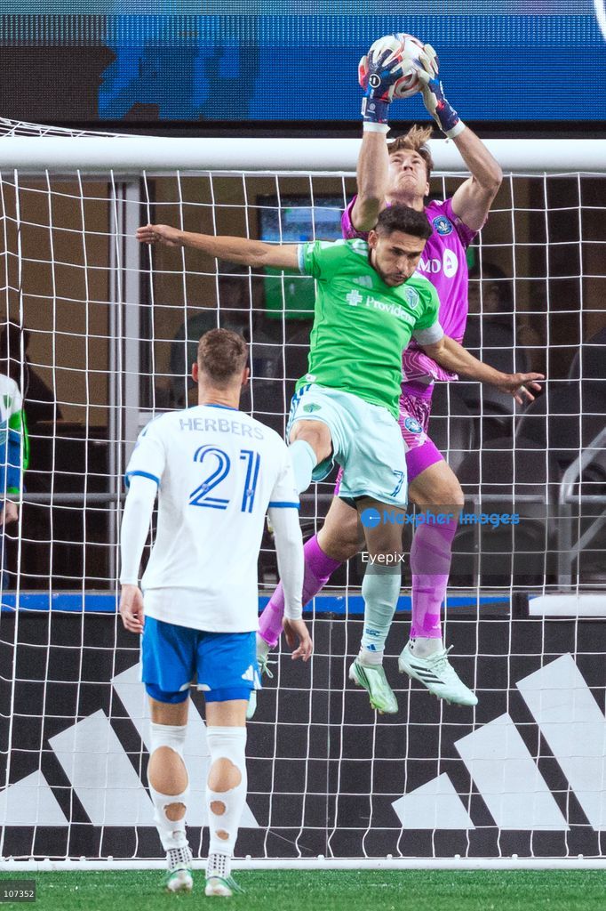 Sébastian Breza #1 of CF Montréal catches the ball against Cristian Roldan #7 of Seattle Sounders FC during the MLS match between Sounders FC and CF Montréal at Lumen Field. on October 17, 2026 in Seattle, Washington. (Photo by Jules Doyle / Eyepix Group/Eyepix via Nexpher Images)