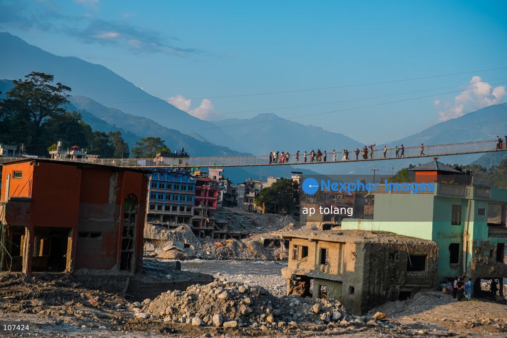 Rasuwa, NEPAL, October 14, 2026: People cross the Trishuli River on a newly installed suspension bridge connecting Trisuli Bazaar in Nuwakot district, Nepal. The bridge provides a crossing over the river for local residents. (Photo by ap tolang/Nexpher Images)