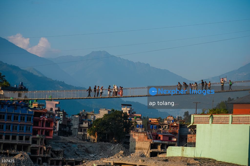 Rasuwa, NEPAL, October 14, 2026: People cross the Trishuli River on a newly installed suspension bridge connecting Trisuli Bazaar in Nuwakot district, Nepal. The bridge provides a crossing over the river for local residents. (Photo by ap tolang/Nexpher Images)