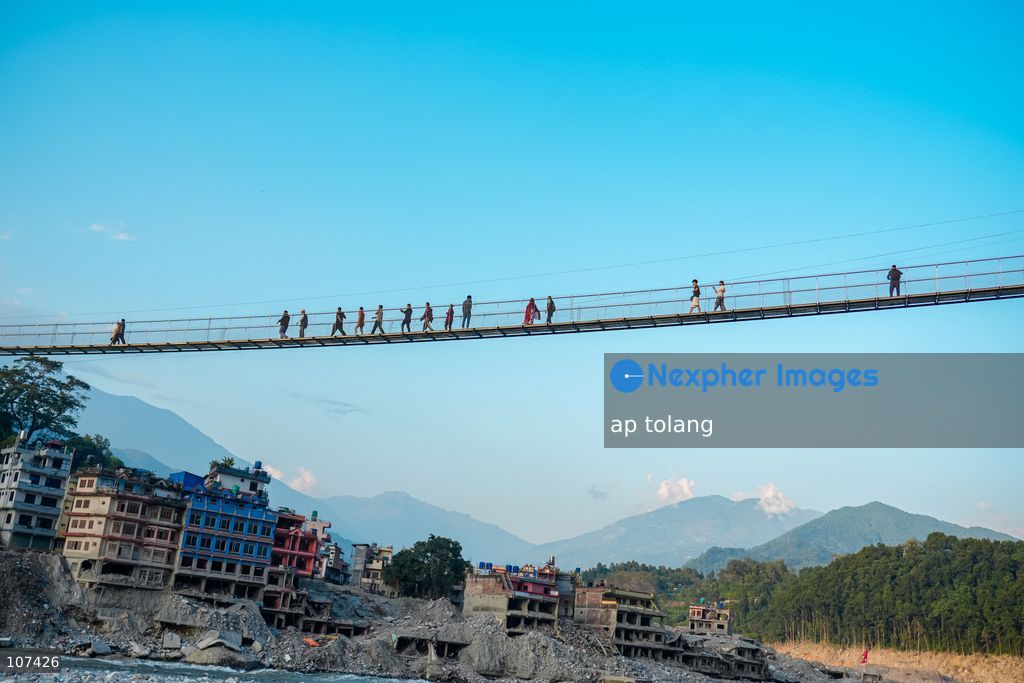 Rasuwa, NEPAL, October 14, 2026: People cross the Trishuli River on a newly installed suspension bridge connecting Trisuli Bazaar in Nuwakot district, Nepal. The bridge provides a crossing over the river for local residents. (Photo by ap tolang/Nexpher Images)