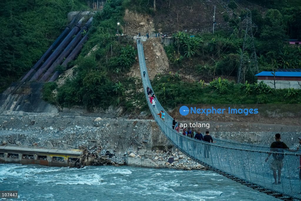 Rasuwa, NEPAL, October 15, 2026: People cross the Trishuli River on a newly installed suspension bridge connecting Trisuli Bazaar in Nuwakot district, Nepal. The bridge provides a crossing over the river for local residents. (Photo by ap tolang/Nexpher Images)