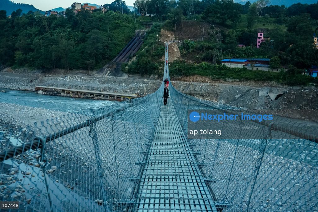Rasuwa, NEPAL, October 15, 2026: People cross the Trishuli River on a newly installed suspension bridge connecting Trisuli Bazaar in Nuwakot district, Nepal. The bridge provides a crossing over the river for local residents. (Photo by ap tolang/Nexpher Images)