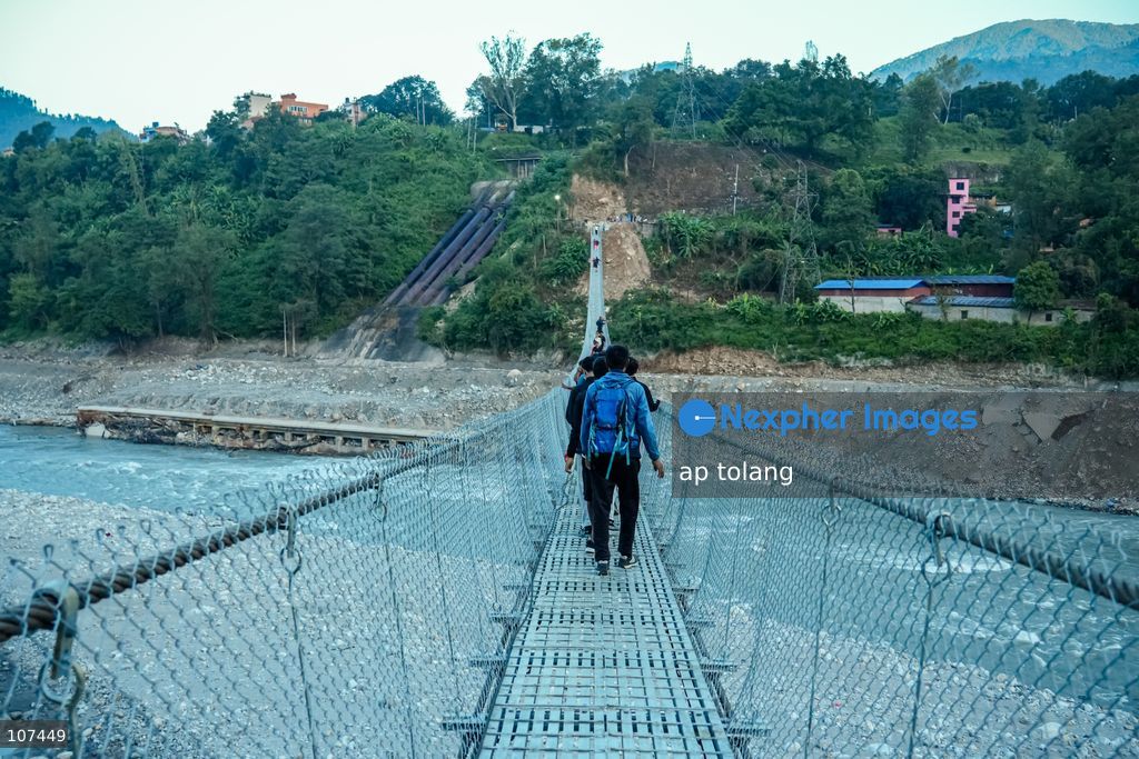Rasuwa, NEPAL, October 15, 2026: People cross the Trishuli River on a newly installed suspension bridge connecting Trisuli Bazaar in Nuwakot district, Nepal. The bridge provides a crossing over the river for local residents. (Photo by ap tolang/Nexpher Images)