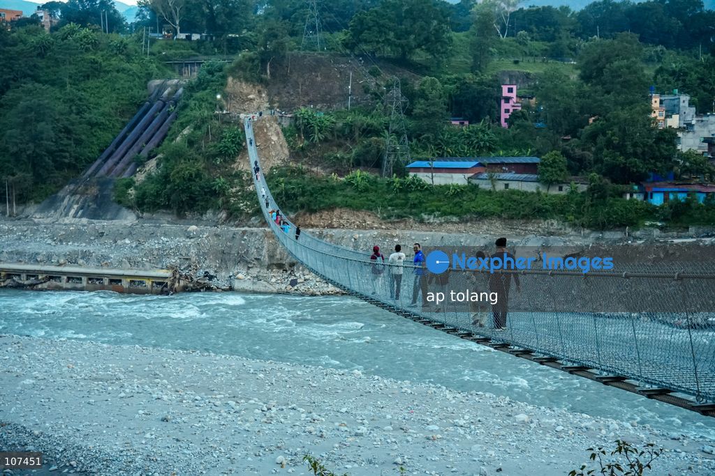 Rasuwa, NEPAL, October 15, 2026: People cross the Trishuli River on a newly installed suspension bridge connecting Trisuli Bazaar in Nuwakot district, Nepal. The bridge provides a crossing over the river for local residents. (Photo by ap tolang/Nexpher Images)