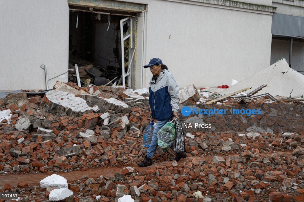 KRAMATORSK, UKRAINE, OCTOBER 19, 2026: People clear debris at the Good News church in Kramatorsk, Donetsk region, a day after the building was hit by a Russian airstrike. Debris removed from inside is burned during the cleanup, while a car parked outside has shattered windows and a damaged tyre. (Photo by Andrew Cling/JNA Press via Nexpher Images)