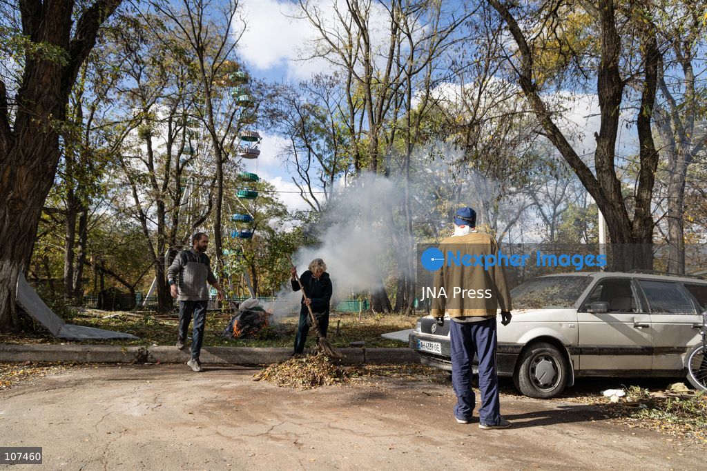 KRAMATORSK, UKRAINE, OCTOBER 19, 2026: People clear debris at the Good News church in Kramatorsk, Donetsk region, a day after the building was hit by a Russian airstrike. Debris removed from inside is burned during the cleanup, while a car parked outside has shattered windows and a damaged tyre. (Photo by Andrew Cling/JNA Press via Nexpher Images)