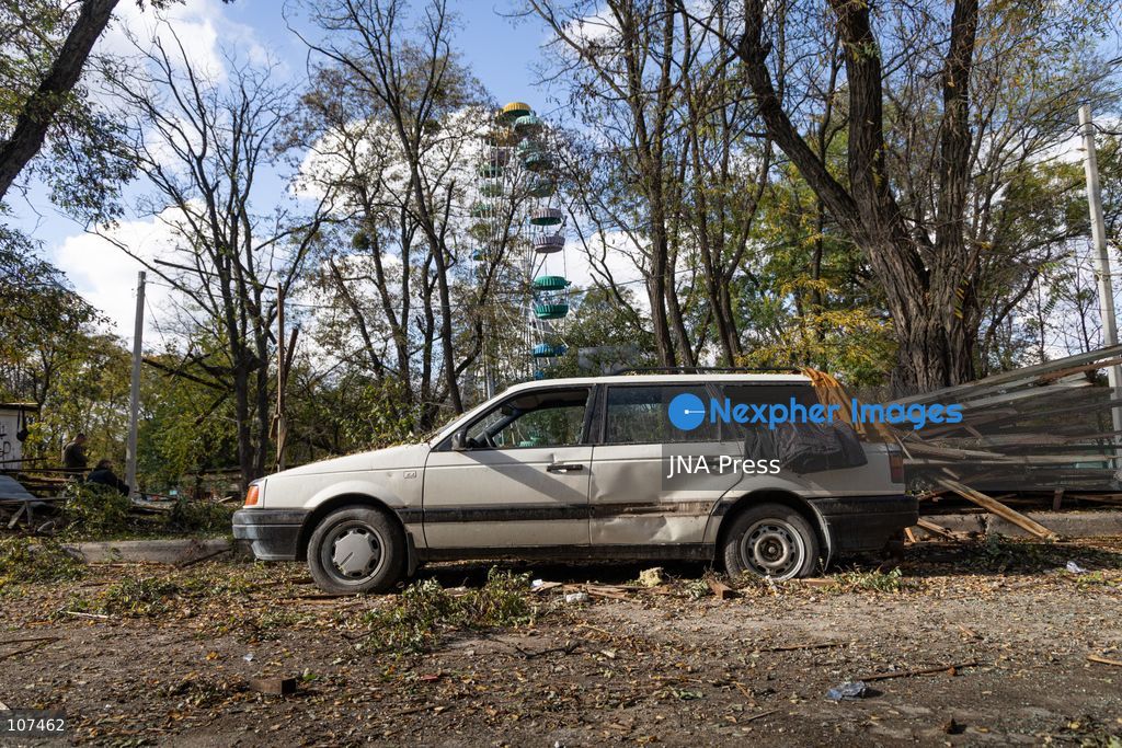 KRAMATORSK, UKRAINE, OCTOBER 19, 2026: People clear debris at the Good News church in Kramatorsk, Donetsk region, a day after the building was hit by a Russian airstrike. Debris removed from inside is burned during the cleanup, while a car parked outside has shattered windows and a damaged tyre. (Photo by Andrew Cling/JNA Press via Nexpher Images)