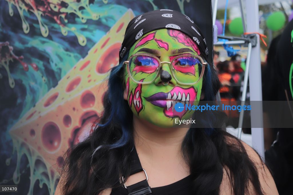 A woman with her face made up takes part in the 19th annual "Zombie Walk Mexico" (Marcha Zombie) along Reforma Avenue. Thousands of people dressed up as the undead gathered for the annual parade for Halloween celebrations on October 18, 2026 in Mexico City, Mexico. (Photo by Carlos Santiago/ Eyepix Group/Eyepix via Nexpher Images)