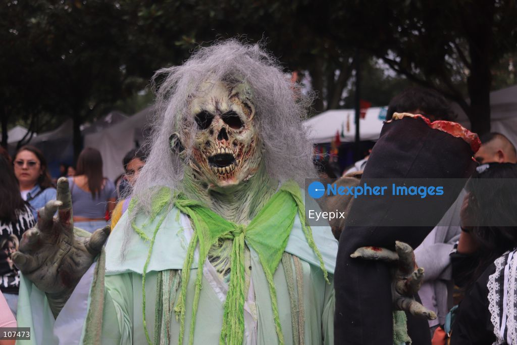 A participant disguised as zombie takes part in the 19th annual "Zombie Walk Mexico" (Marcha Zombie) along Reforma Avenue. Thousands of people dressed up as the undead gathered for the annual parade for Halloween celebrations on October 18, 2026 in Mexico City, Mexico. (Photo by Carlos Santiago/ Eyepix Group/Eyepix via Nexpher Images)
