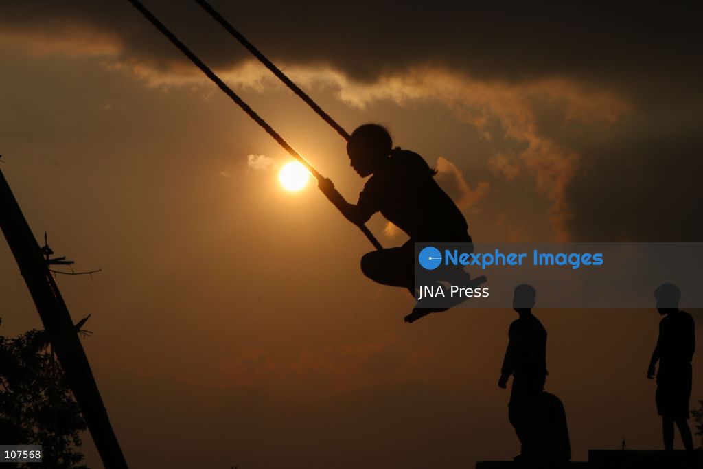 BHAKTAPUR, NEPAL, OCTOBER 19, 2026: People play on a traditional bamboo swing, known as linge ping, during Dashain celebrations in the hilly outskirts of the Kathmandu Valley. Such swings are erected in communities across Nepal as part of the festival’s traditions. (Photo by Shankar Bhujel/JNA Press via Nexpher Images)