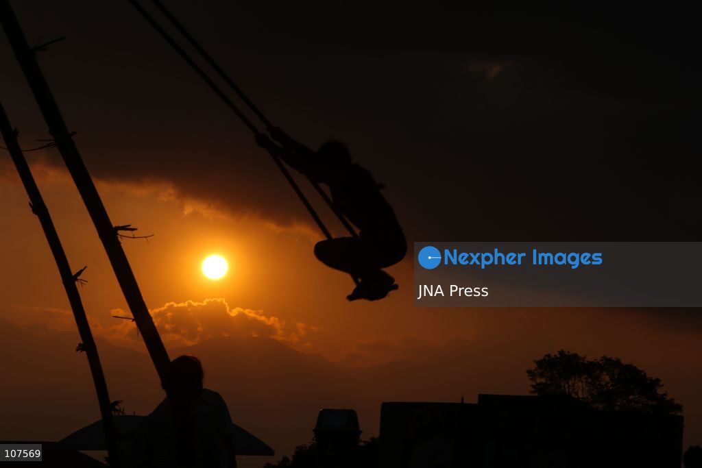 BHAKTAPUR, NEPAL, OCTOBER 19, 2026: People play on a traditional bamboo swing, known as linge ping, during Dashain celebrations in the hilly outskirts of the Kathmandu Valley. Such swings are erected in communities across Nepal as part of the festival’s traditions. (Photo by Shankar Bhujel/JNA Press via Nexpher Images)