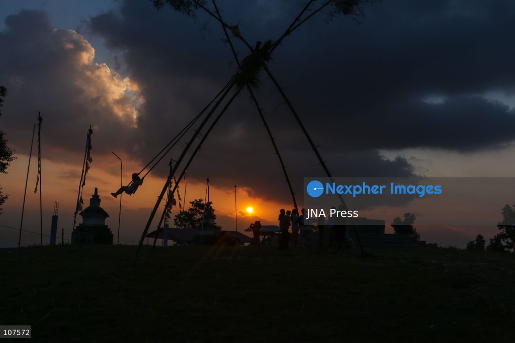 BHAKTAPUR, NEPAL, OCTOBER 19, 2026: People play on a traditional bamboo swing, known as linge ping, during Dashain celebrations in the hilly outskirts of the Kathmandu Valley. Such swings are erected in communities across Nepal as part of the festival’s traditions. (Photo by Shankar Bhujel/JNA Press via Nexpher Images)