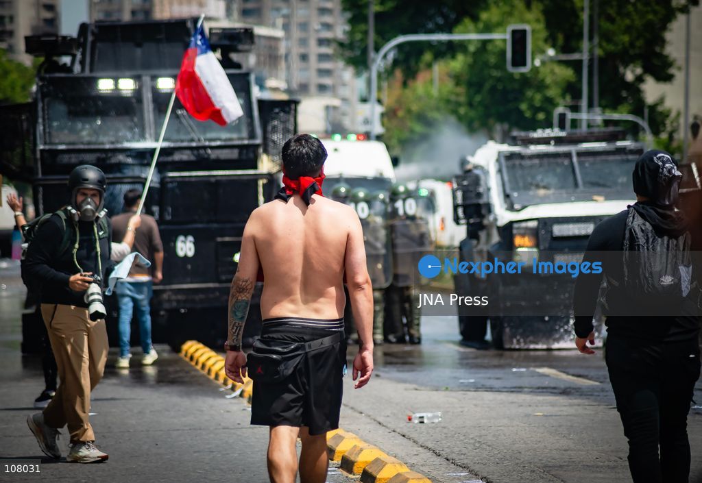 SANTIAGO, CHILE, OCTOBER 19, 2026: Demonstrators march in Santiago to mark the seventh anniversary of Chile’s 2019 social uprising, known as the “estallido social.” The movement began with protests against increased metro fares and developed into nationwide demonstrations over inequality, the cost of living and access to public services. (Photo by Mauro Arlegui/JNA Press via Nexpher Images)