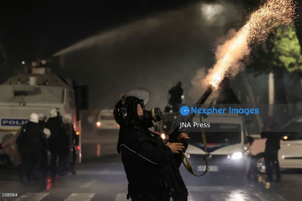 TIRANA, ALBANIA - OCTOBER 20, 2026: Anti-government protests continue in Tirana for an eighth consecutive day, with demonstrators gathering in central areas of the capital, including Skanderbeg Square. Protesters call for the resignation of Prime Minister Edi Rama, demanding improvements to university conditions and broader political change. Tensions escalate as Albanian riot police fire tear gas to disperse demonstrators. One protester collapses in Skanderbeg Square after tear gas is deployed. Amid the confrontations, a young demonstrator is also seen reaching out to shake hands with a riot police officer, offering a contrasting moment during the tense demonstrations. The protests reflect growing public discontent and continued tensions between demonstrators and the authorities. (Photo by Vlasov Sulaj/JNA Press via Nexpher Images)