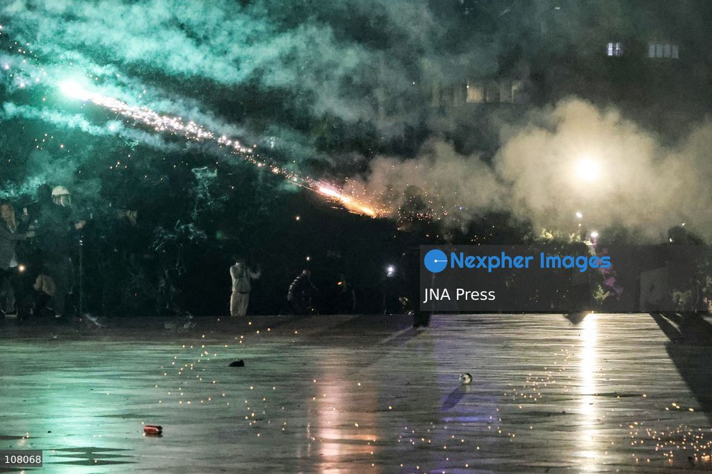 TIRANA, ALBANIA - OCTOBER 20, 2026: Anti-government protests continue in Tirana for an eighth consecutive day, with demonstrators gathering in central areas of the capital, including Skanderbeg Square. Protesters call for the resignation of Prime Minister Edi Rama, demanding improvements to university conditions and broader political change. Tensions escalate as Albanian riot police fire tear gas to disperse demonstrators. One protester collapses in Skanderbeg Square after tear gas is deployed. Amid the confrontations, a young demonstrator is also seen reaching out to shake hands with a riot police officer, offering a contrasting moment during the tense demonstrations. The protests reflect growing public discontent and continued tensions between demonstrators and the authorities. (Photo by Vlasov Sulaj/JNA Press via Nexpher Images)