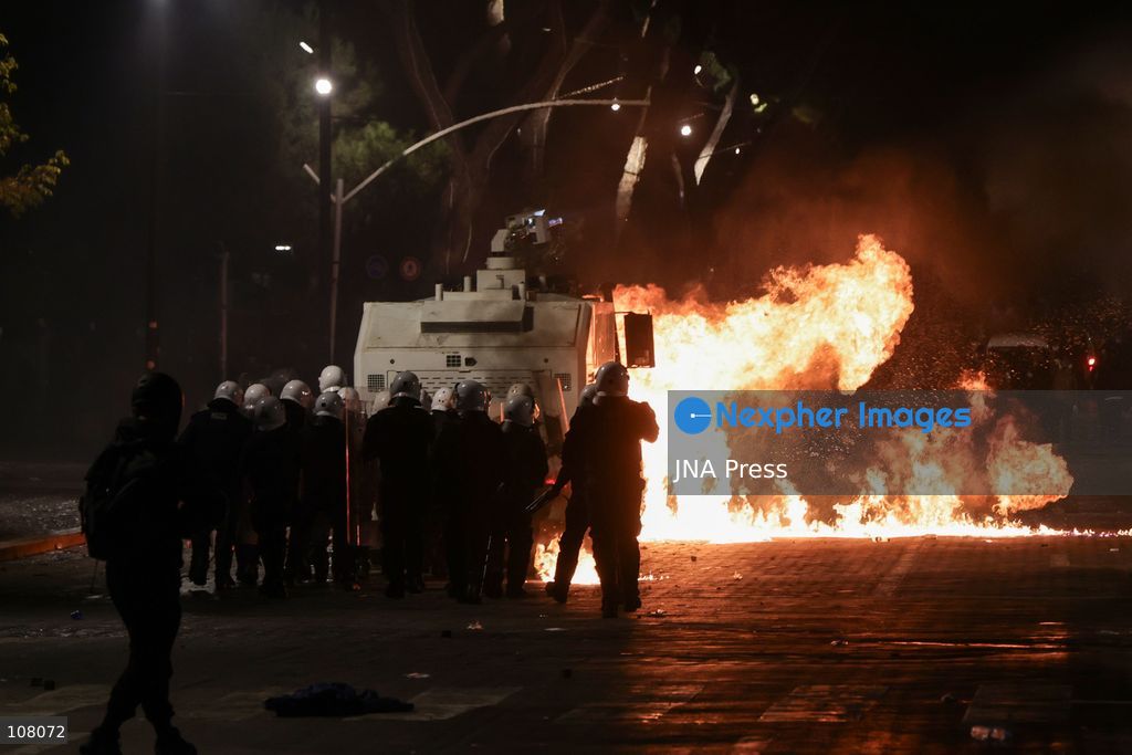 TIRANA, ALBANIA - OCTOBER 20, 2026: Anti-government protests continue in Tirana for an eighth consecutive day, with demonstrators gathering in central areas of the capital, including Skanderbeg Square. Protesters call for the resignation of Prime Minister Edi Rama, demanding improvements to university conditions and broader political change. Tensions escalate as Albanian riot police fire tear gas to disperse demonstrators. One protester collapses in Skanderbeg Square after tear gas is deployed. Amid the confrontations, a young demonstrator is also seen reaching out to shake hands with a riot police officer, offering a contrasting moment during the tense demonstrations. The protests reflect growing public discontent and continued tensions between demonstrators and the authorities. (Photo by Vlasov Sulaj/JNA Press via Nexpher Images)