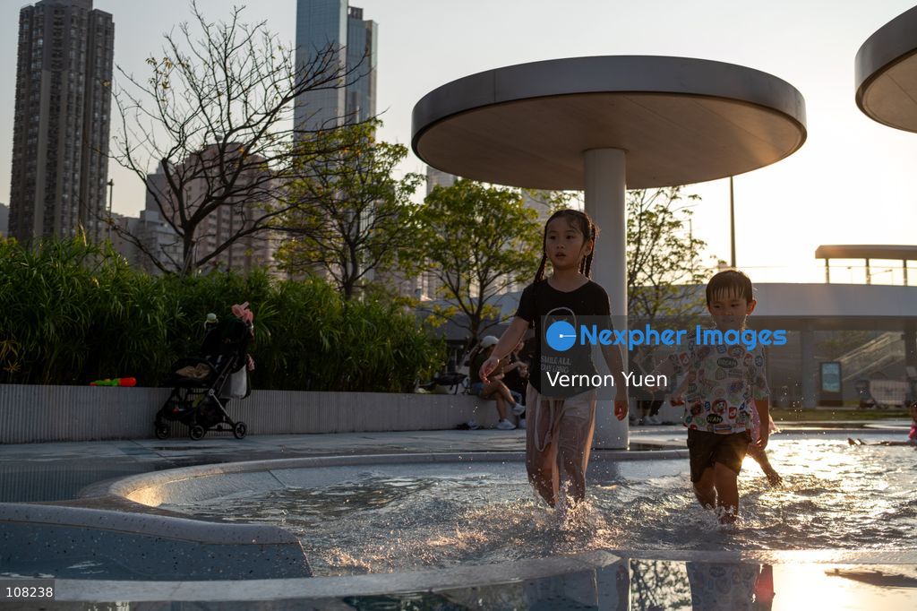 Children playing with water at a water playing area in a playground on October 21, 2026 in Hong Kong. (Photo by Vernon Yuen/Nexpher Images)