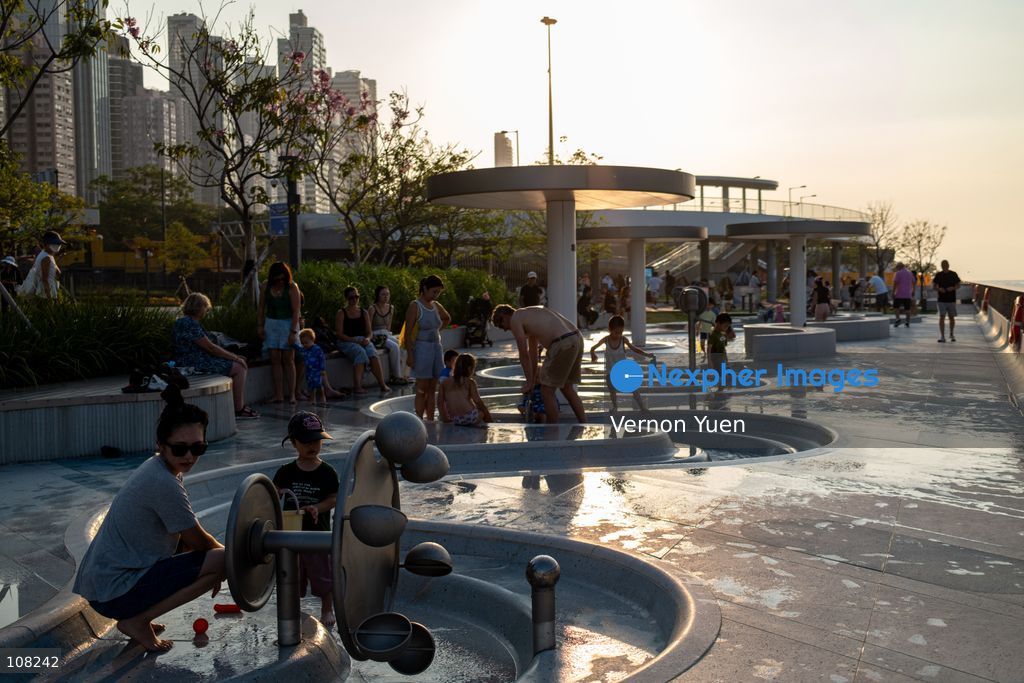 Children playing with water at a water playing area in a playground on October 21, 2026 in Hong Kong. (Photo by Vernon Yuen/Nexpher Images)